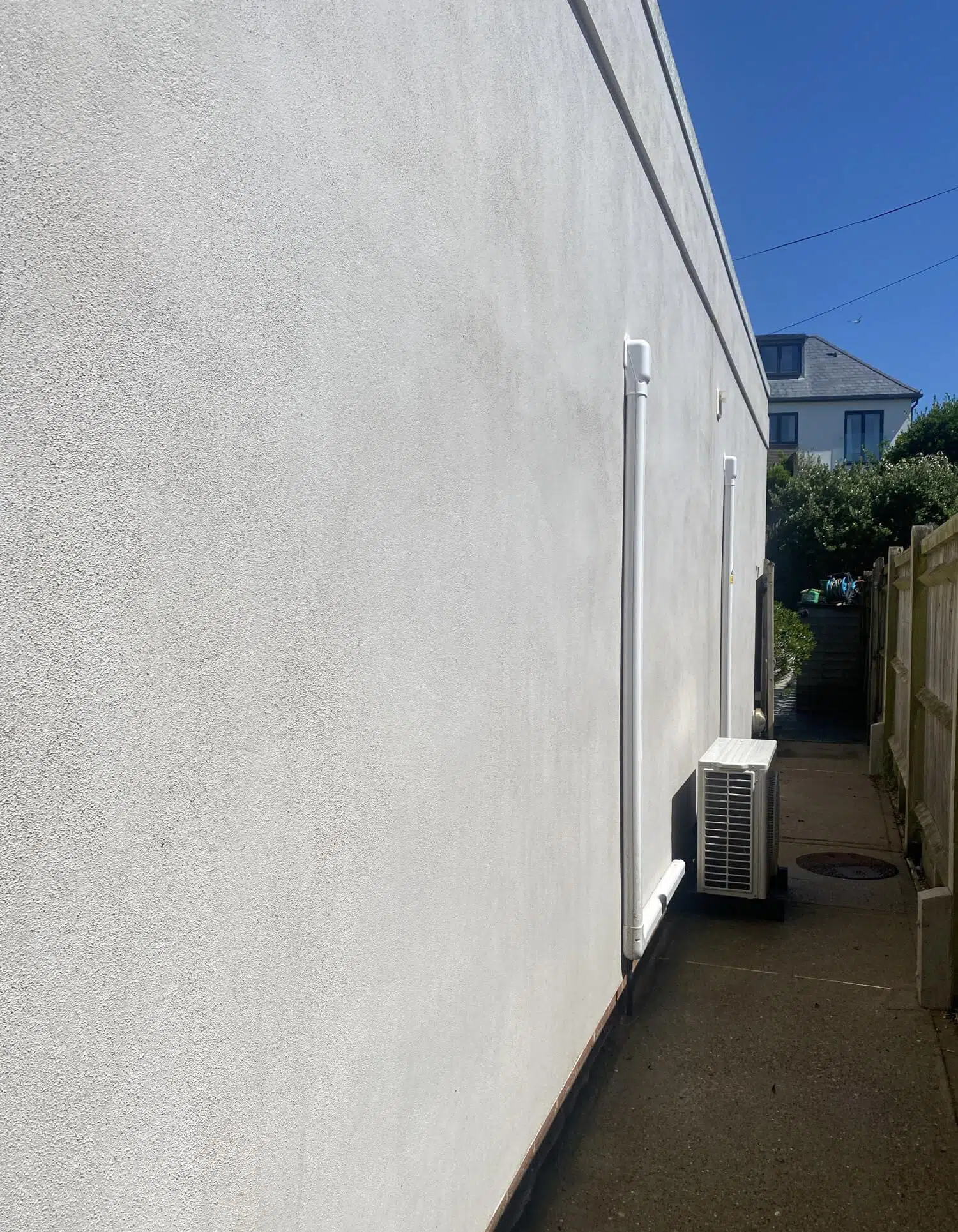 Professional exterior cleaning of a building wall in Woking.